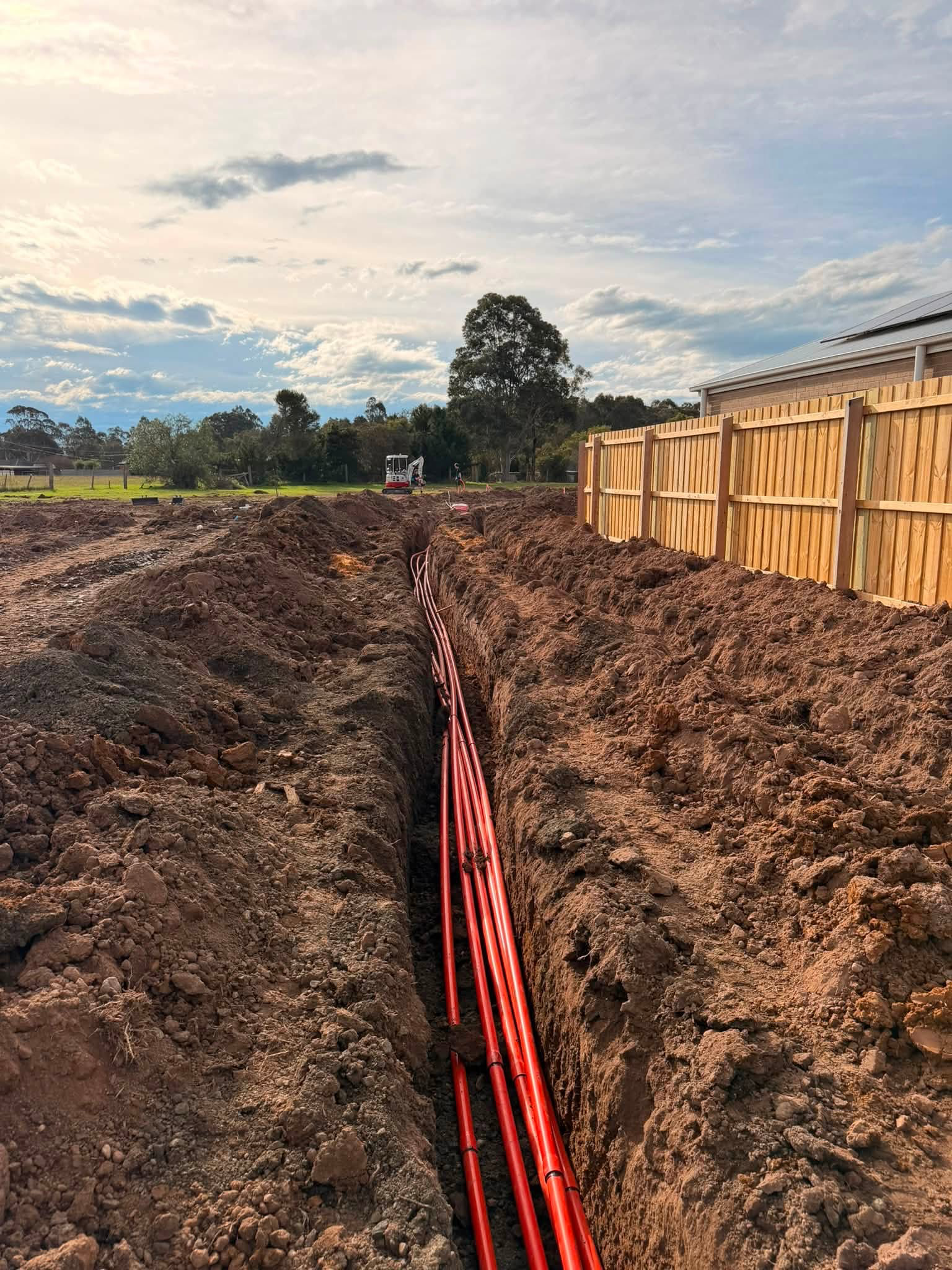 Red underground conduits in trench