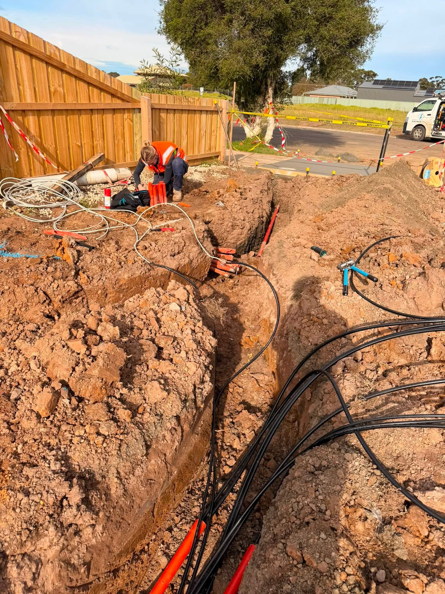 Worker installing underground cables