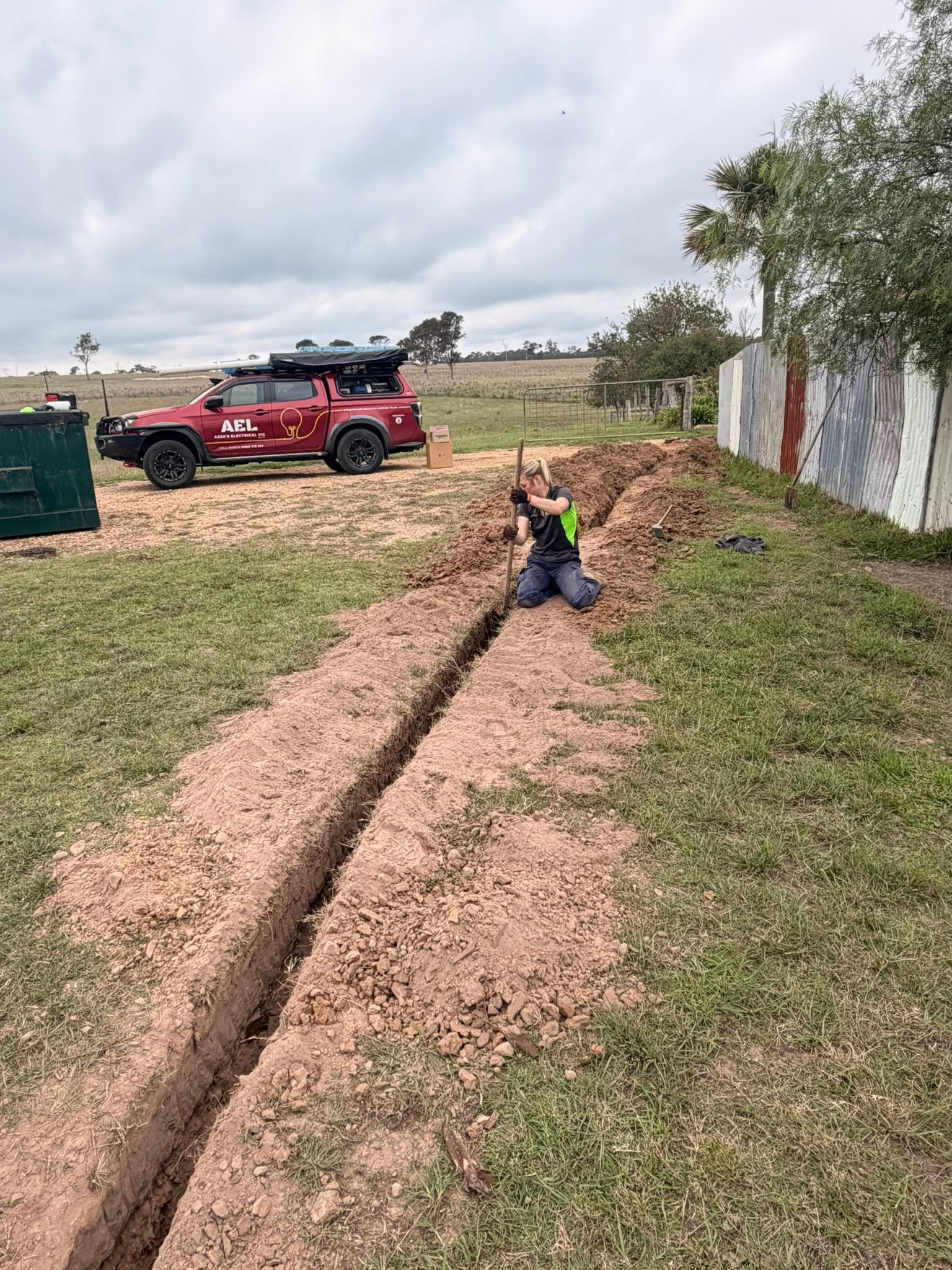 Worker preparing rural power trench